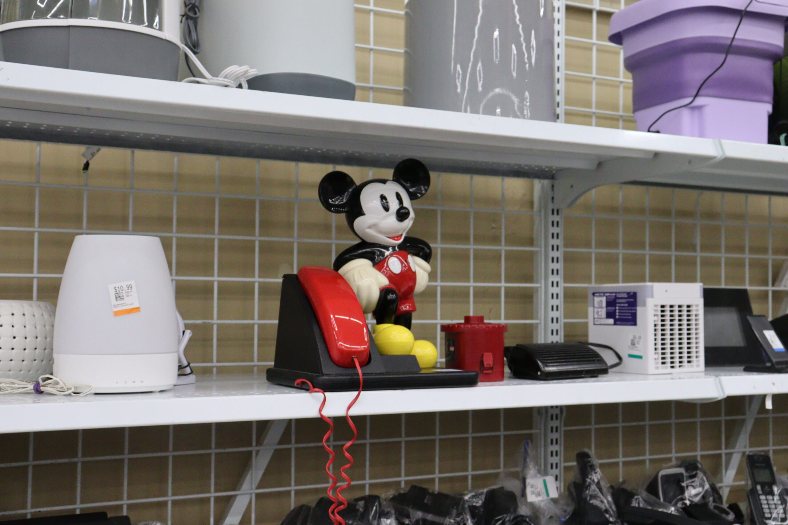 The purpose of this photograph was to focus on a red object. I found this vintage Mickey Mouse telephone alongside other generic looking and less colourful electronics and thought it stood out well amongst them being the only red object in this part of the shelf so... here he is.