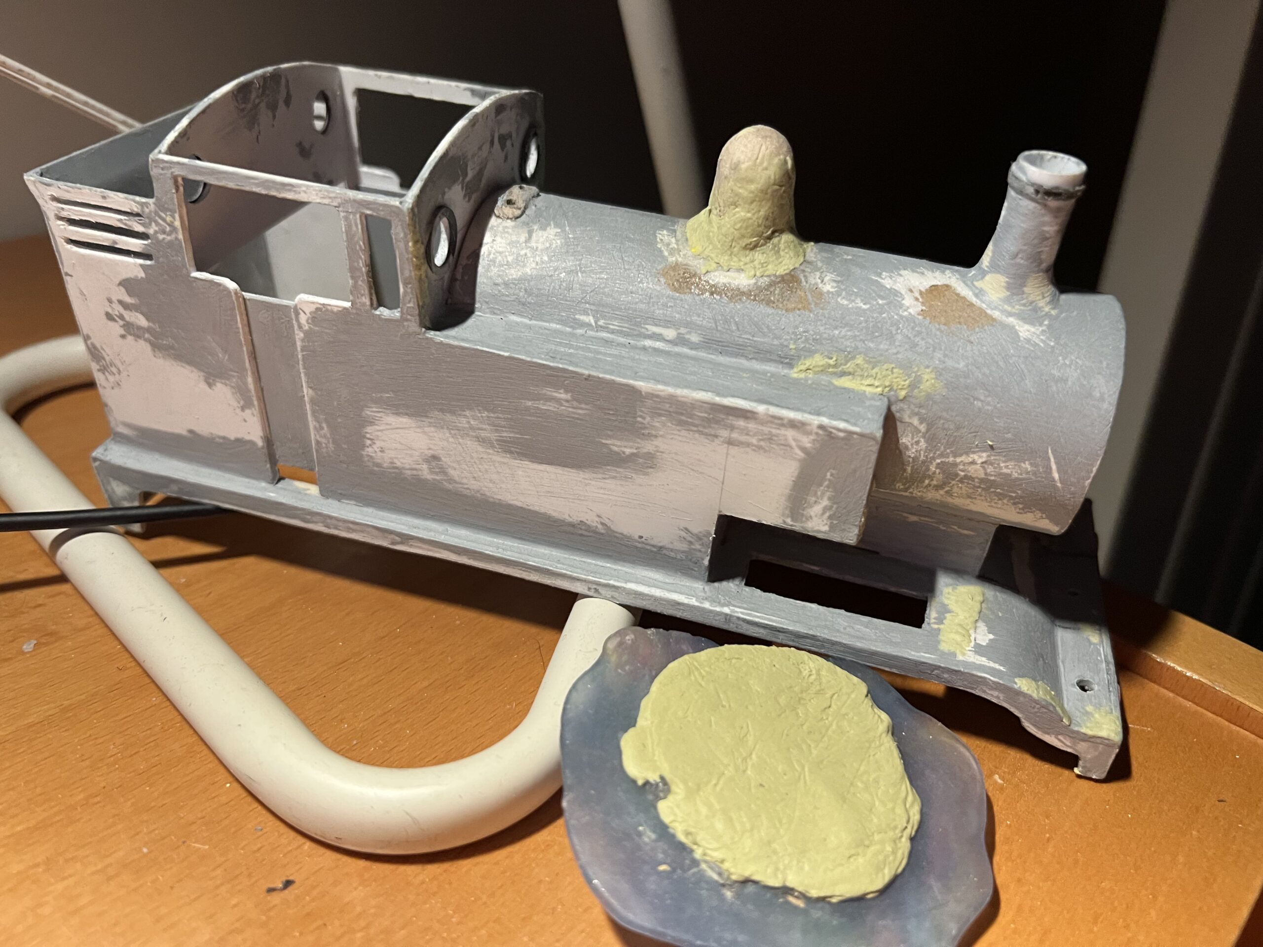 Here, I used Milliput to fill in the gaps of my Thomas model. On the bottom right is a mould made from Oyumaru with Milliput pressed inside it.